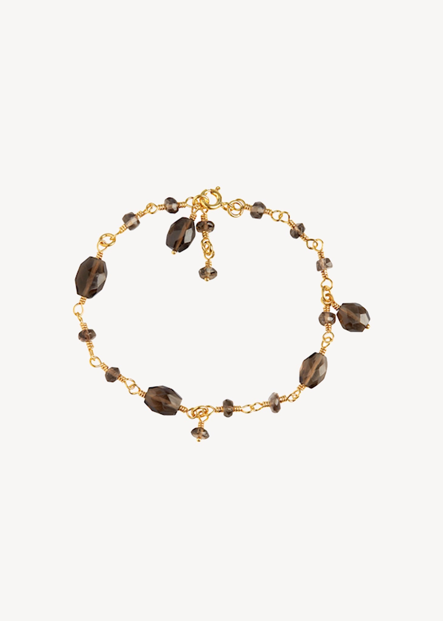 Guld armbånd med store brune kvarts ædelsten på udsalg til hende 