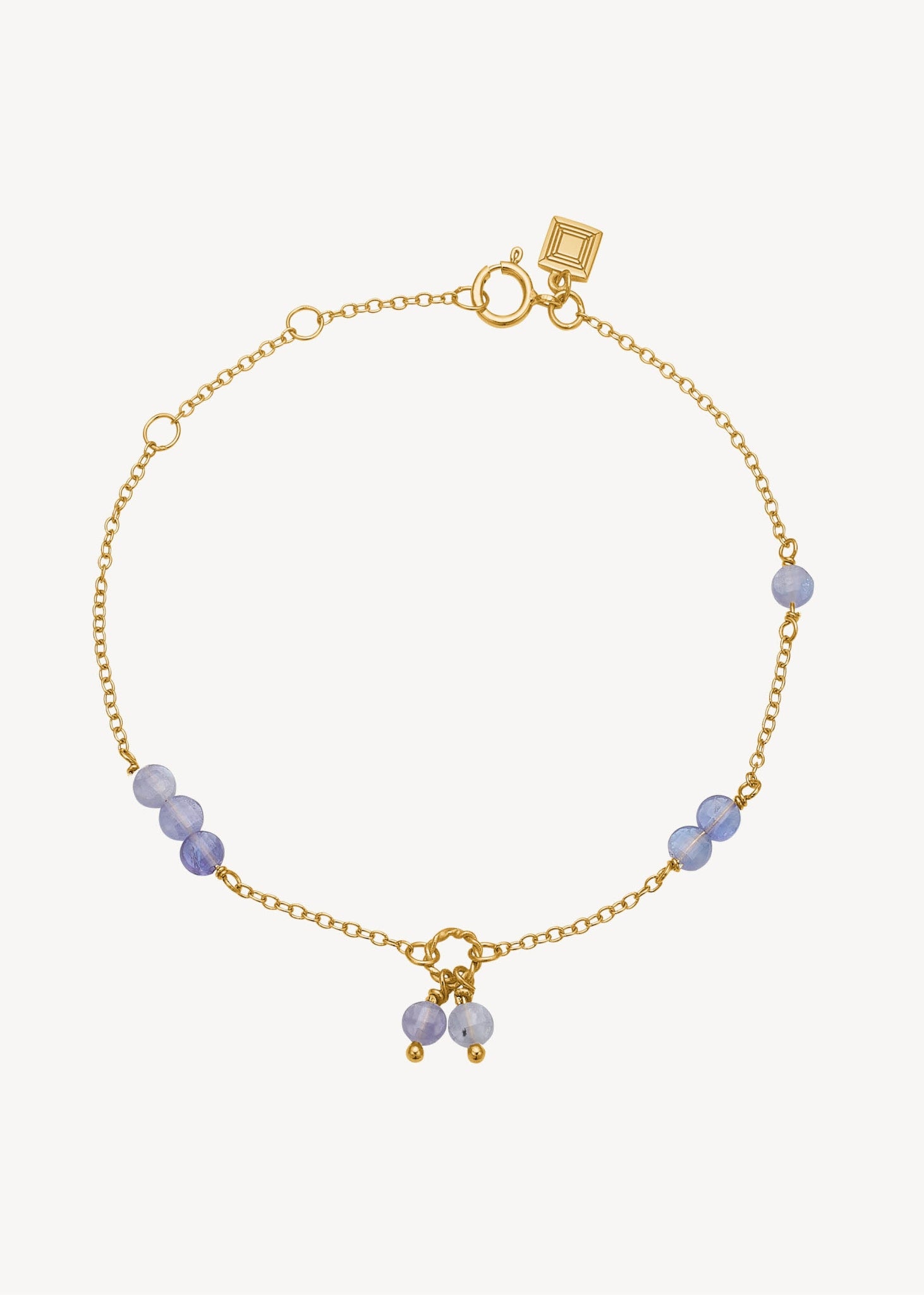sødt armbånd i guld med lilla tanzanit ædelsten, perfekt gave til hende og gave til mor