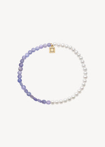Håndlavet ædelstens armbånd fra carré jewellery lavet med genanvendte ædelsten sat med hvide ferskvandsperler og lilla tanzanit ædelsten til konfirmationen 2025
