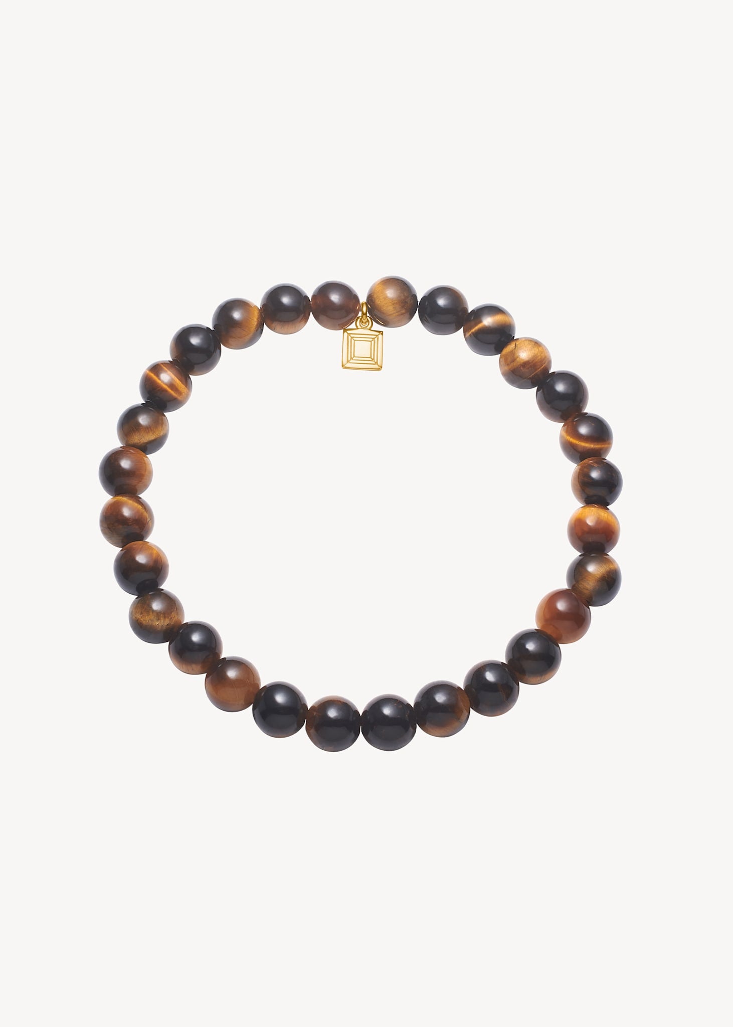 Smukt slip-on armbånd til kvinder i guldbelagt sølv med elastik snor sat med brune og orange tigerøje ædelsten