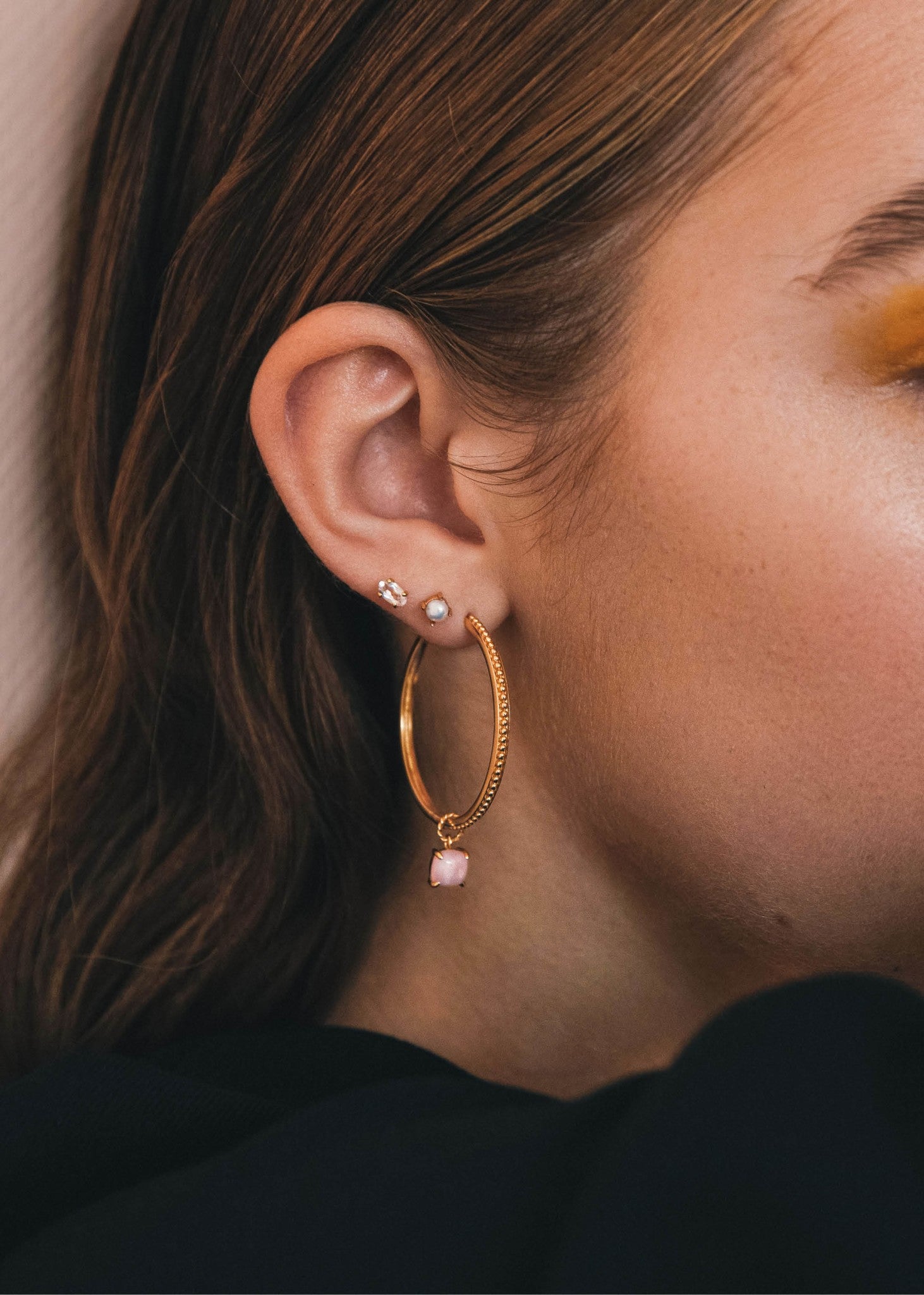Kvinde med store guld hoops i sterling sølv med antikt mønster til hoops og charms i 3,5 cm 