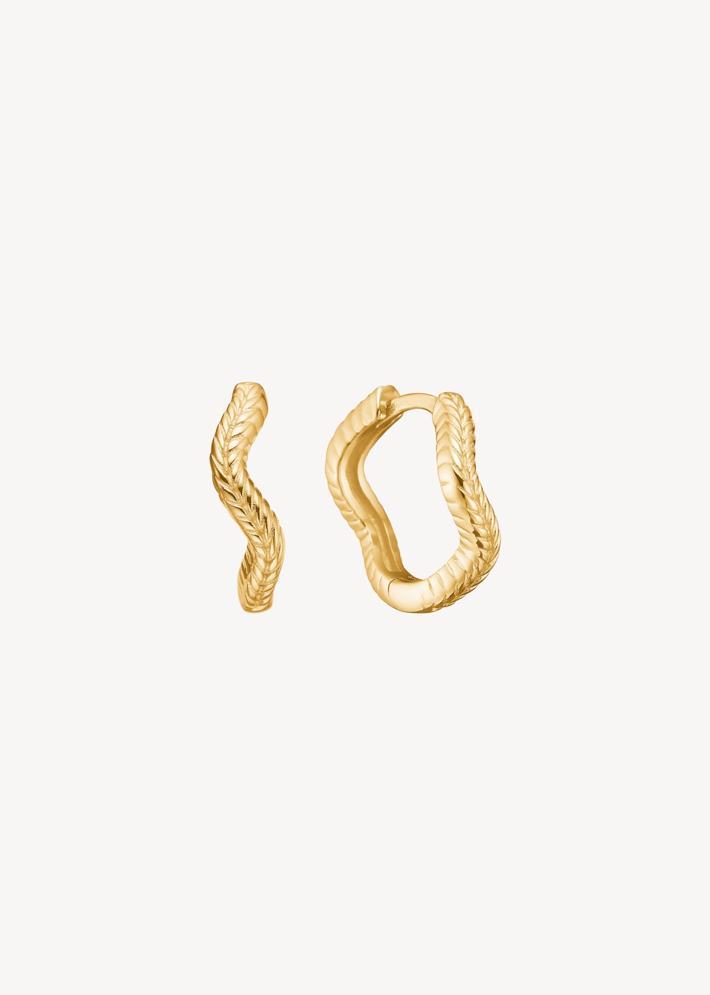 Wave hoops fra carré jewellery i guldbelagt sterling sølv med creol lukning i en organisk bugtet form.